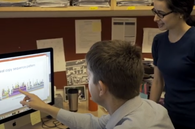 Trainee and faculty looking at screen